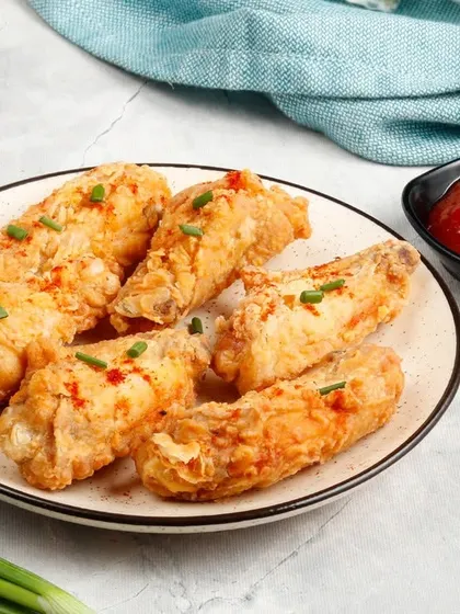A close-up of our perfectly fried chicken wings, showcasing their crispy texture. A must-try for anyone craving a simple yet delicious starter.