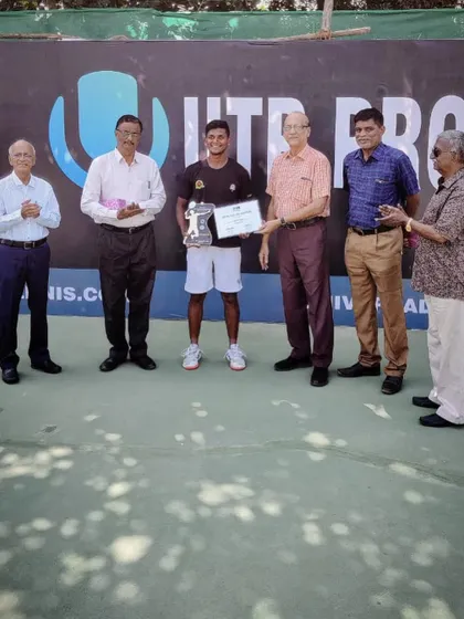 Ishaque Eqbal being presented with his winner's trophy at the UTR Pro Tennis Tour event. This is a significant achievement in the professional tennis landscape.