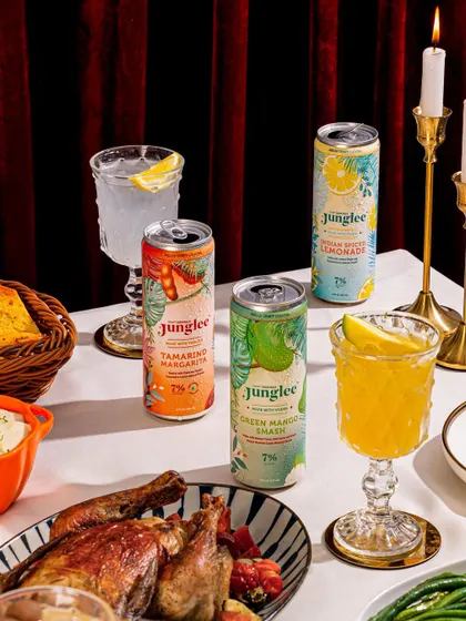 A festive table setting featuring canned cocktails alongside a holiday meal. This seasonal content helps brands stay relevant throughout the year.
