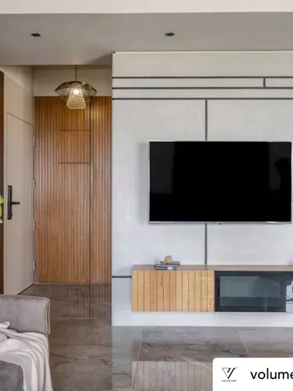 The TV and media unit in Rustic Reverie was custom designed for both form and function. The floating console with fluted wood details keeps the space feeling light, while the asymmetrical shelving and geometric wall lines add visual interest without creating clutter.