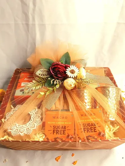 A beautifully wrapped Diwali hamper, ready to be gifted. This one features sugar-free chocolates, copper glasses, and other healthy treats, showing that festive indulgence can also be mindful.