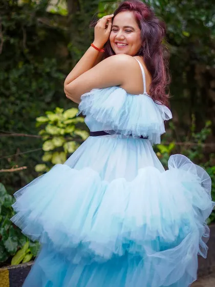 A joyful shot of our client in the blue ruffle gown. It's a dress that's guaranteed to make you smile.