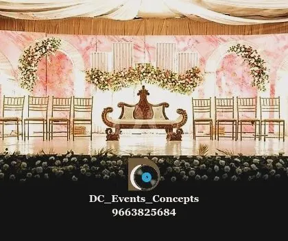 A wide shot of the pink marble wedding stage before the festivities begin. This view highlights the full scale of the decor, from the floral arrangements to the seating plan, all designed to work in harmony.