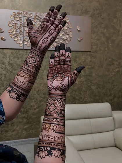 A different view of the detailed baby shower mehendi, showing the intricate patterns and storytelling elements from another angle.