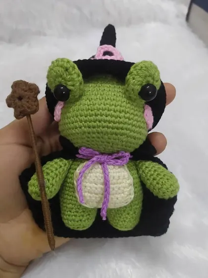 Holding the wizard frog to show his size. He's a handful of magic and cuteness.