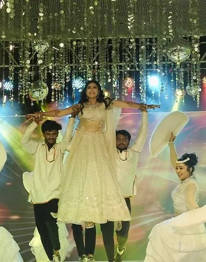 A duplicate of image 17, this is the hero shot of the performance, capturing the bride's triumphant lift with pyrotechnics for a truly cinematic finish.