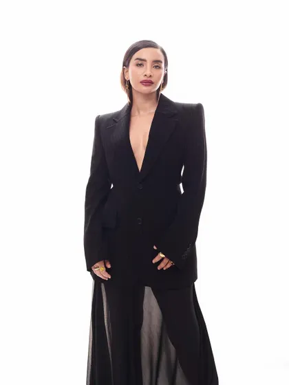 The full, statuesque look. This image showcases the elongated silhouette created by the longline blazer and flowing sheer skirt.