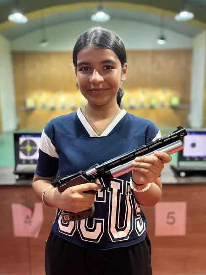 Pahel Jain with her air pistol after winning a gold medal at the 11th West Zone Competition.