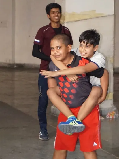 Fun and games during a training session. Partner exercises like these build strength, trust, and camaraderie among our fencers.