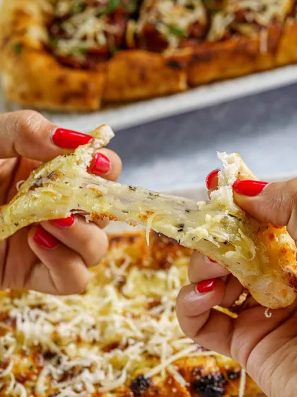 A cheesy garlic bread pull-apart shot for Buono Pizzeria in Alibaug. This image is designed to be satisfying and mouth-watering, perfect for social media.