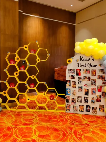 A unique honeycomb shelf display and a personalized 'First Year' photo board from Keev's honeybee-themed party.
