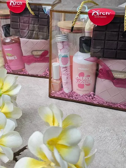 Another view of our custom Rakhi hampers for sisters, showcasing the elegant transparent packaging and the variety of products inside.