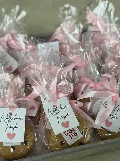 A tray of individually packaged eggless cookies with custom "With love" tags, perfect for party favors or event giveaways.