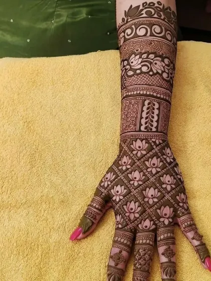 A closer look at a full-arm bridal design, showing the fine lines and detailed patterns like the lotus grid and peacock band that we specialize in.
