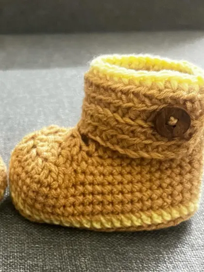 Another view of the adjustable baby bootie. The combination of the brown yarn and yellow trim is one of my favorite classic looks for baby items.