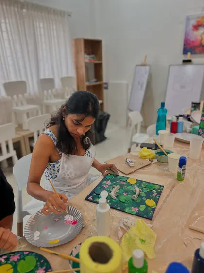A close-up of an artist painting her Koi Fish canvas. The process is just as beautiful as the final result.