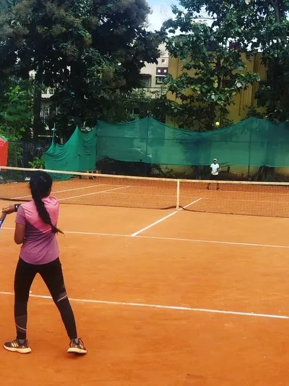 A junior girl returns a shot during a match in the Juniors and Men’s Open Tournament.