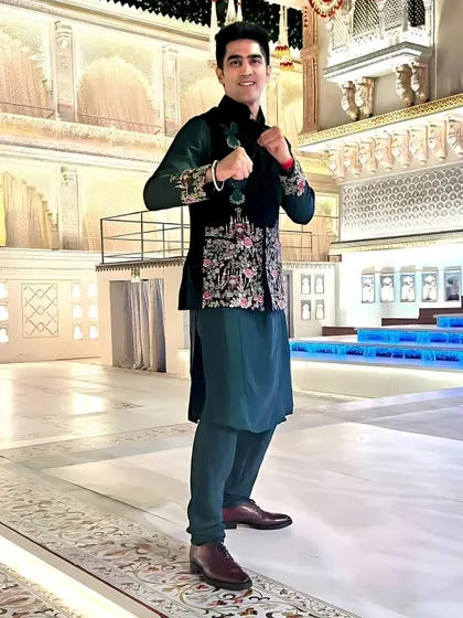 A full view of the velvet green Jawahar jacket ensemble. The tailored fit and luxurious materials create a look of regal elegance, perfect for a high-profile celebration.