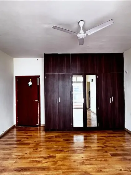 Another 'before' shot of the master bedroom, showing the original dark wood wardrobe.
