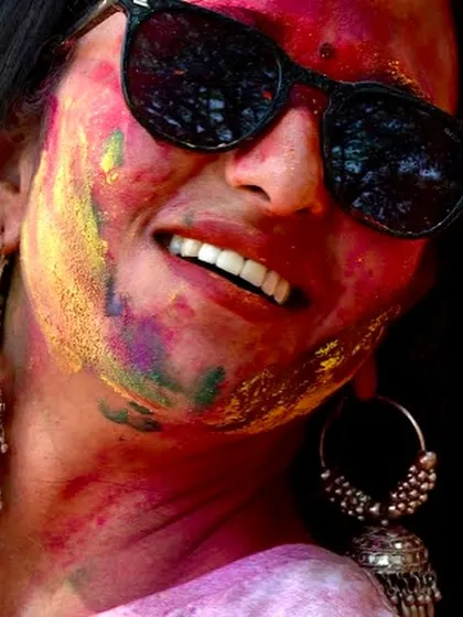 A happy smile covered in colors. This is the result of a successful Holi dance party where everyone lets go of their inhibitions and just has fun.