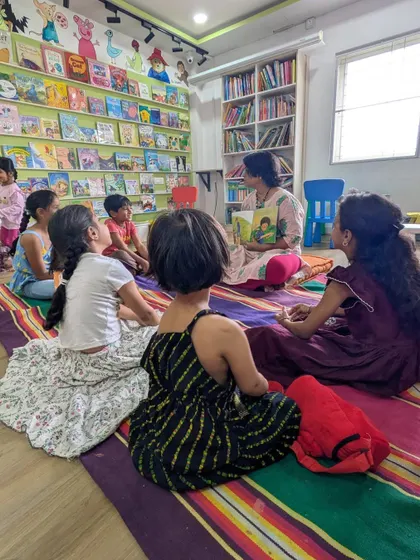 A full view of our Kannada Book Club, showing kids of various ages gathered to enjoy a story together. We welcome all levels of fluency.