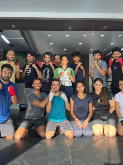 Our diverse team, including men and women, posing together after a training session. Everyone is welcome in our family.
