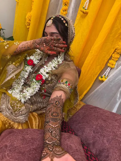 A candid shot of the bride during the ceremony, with her beautifully adorned hands.