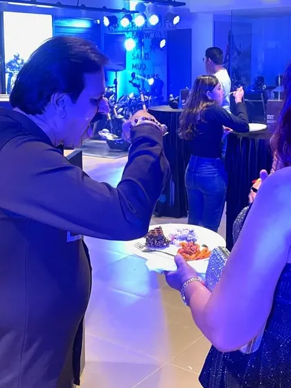 A guest enjoying a plate of our food at the Triumph motorcycle showroom launch. We ensure that even at a busy networking event, the food is delicious, easy to eat, and served professionally.