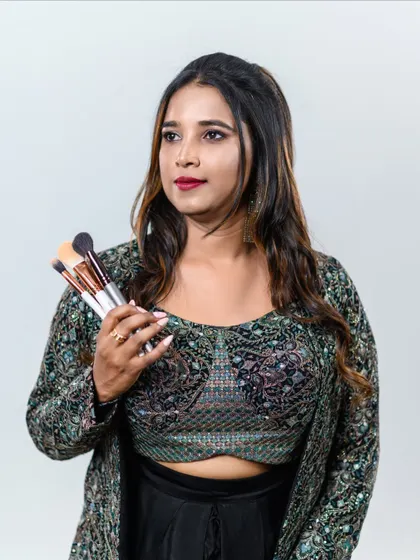 Holding my brushes, my tools of creation. With 20 years in the industry, I am passionate about sharing every trick I have learned with my students.