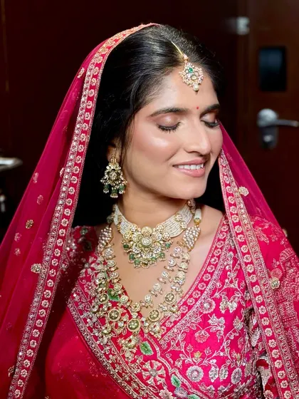 A serene portrait of the bride with her eyes closed, showcasing the soft and blended eyeshadow work.
