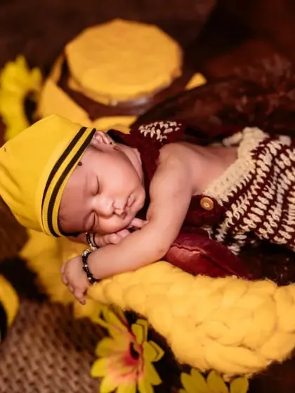 A sleeping baby bee, curled up with a crochet prop. This detailed shot highlights the creative costumes and props I use for newborn sessions.