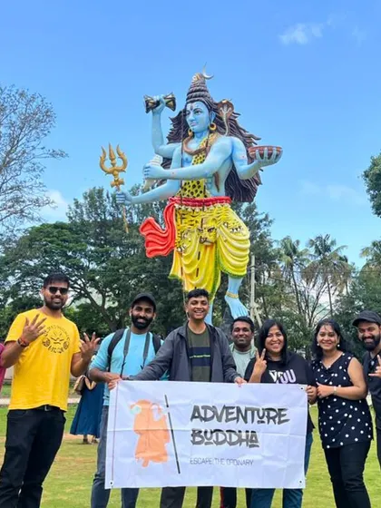 Our group with the banner in front of a Shiva statue near Nandi Hills.