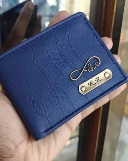 This navy blue wallet in a crocodile finish is customized with initials and an infinity love charm. It's a subtle yet meaningful personalization.