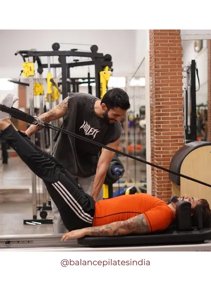 Pilates is for the boys too. Here's our trainer working one-on-one with a male client to perfect his form and build serious core strength.