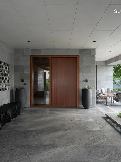 The entrance of Residence 338 features a striking wall art installation and a warm wooden door, setting a tone of artistic sophistication from the moment you arrive.