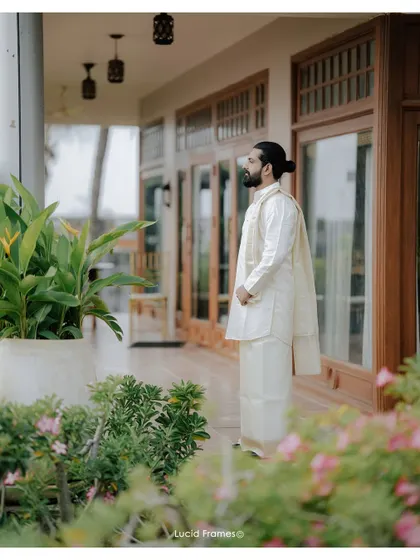 The groom, looking thoughtful and elegant in his traditional mundu, awaits his bride.