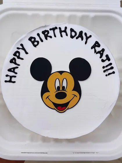 A simple and classic Mickey Mouse bento cake. The iconic face is an edible print on a smooth buttercream surface, perfect for any Disney fan.