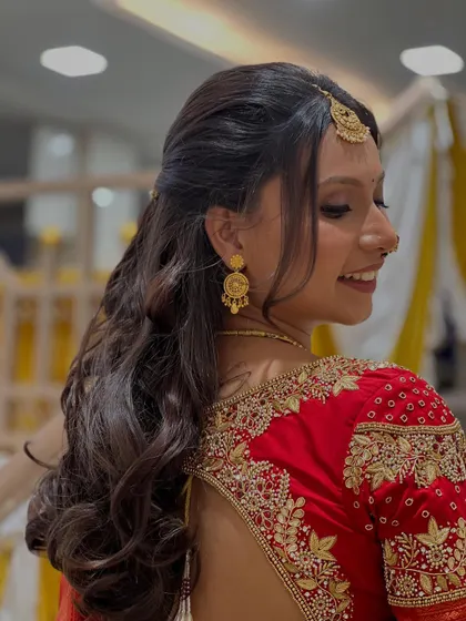 A closer look at the intricate embroidery on the blouse and the beautiful half-up, half-down hairstyle.