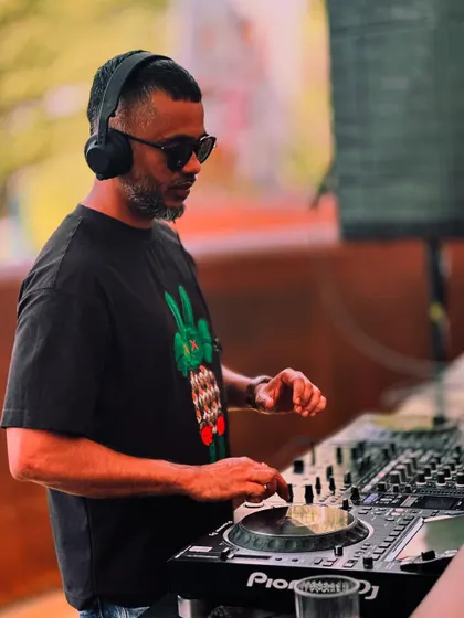 A close-up of me working the Pioneer DJ decks under the sun. Professional equipment is essential for delivering crisp, clear sound in any environment, indoors or out.