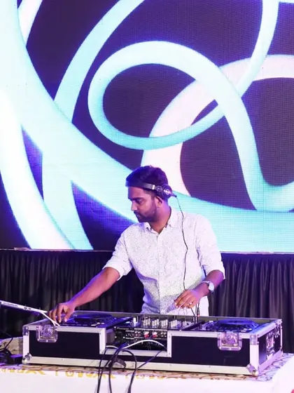 DJing at a large outdoor venue with a custom LED background. My Pioneer setup is perfect for any event size, ensuring crisp sound and a professional look.