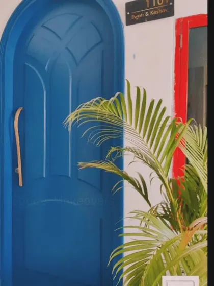 A main door is the first hello from your home. This bold, arched blue door with a unique wooden handle makes a vibrant and welcoming statement, showcasing a personality that isn't afraid of color.