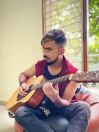A relaxed moment at home, just me and my guitar. This is where new ideas are born and where I practice for hours to perfect my craft for live shows.