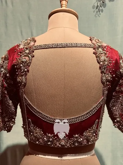 The elegant back of the wine-red blouse.