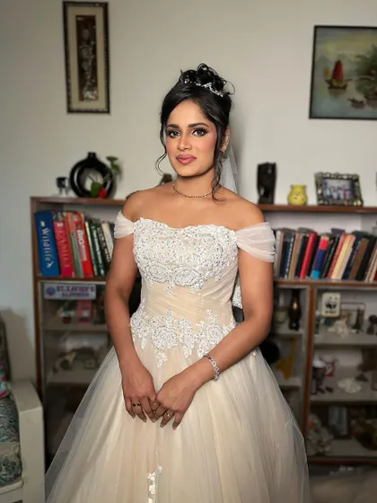 The full view of this angelic white wedding look. The makeup is soft and defined, enhancing her natural beauty for her special day.