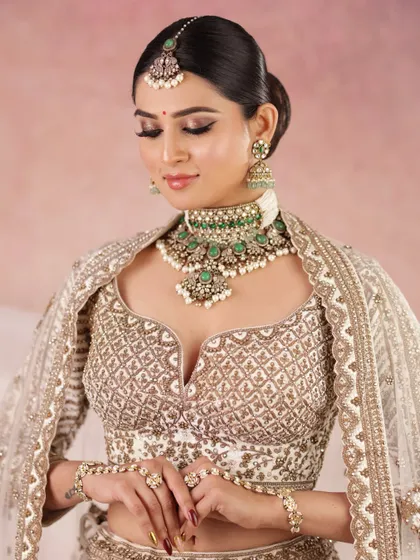 An eyes-closed shot to showcase the precise eye makeup and the flawless, airbrushed finish of the skin.