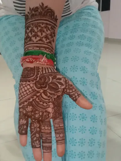 A close-up of a Karwa Chauth mehendi design. The pattern is dense and traditional, featuring classic elements that are perfect for the festival.