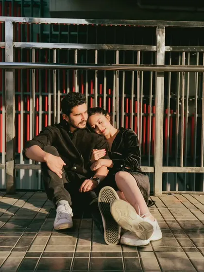 A quiet, reflective moment shared by a couple on a city bridge. This photo captures the feeling of finding peace and connection amidst the hustle and bustle of Mumbai.