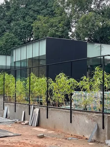 The VPG Centre under construction, with the bamboo landscaping being installed. The simple steel structure and glass walls create a light and elegant building that sits gently in its site.