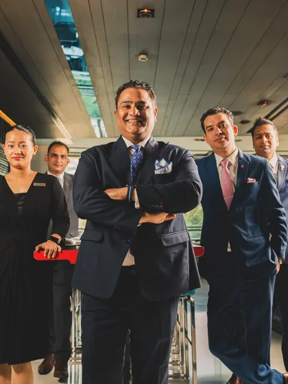 A group portrait of the management and service team at Yauatcha. This shot showcases the entire front-of-house leadership, projecting an image of a professional, unified team ready to welcome guests.