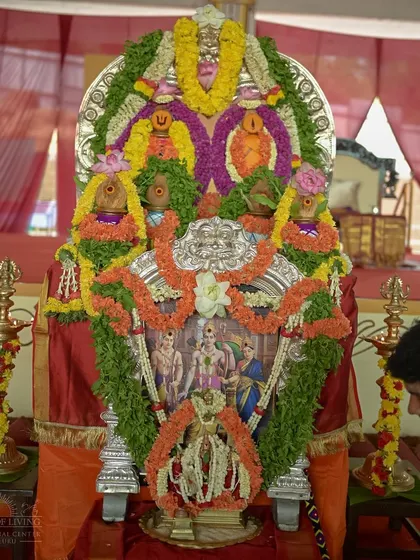 The main altar for the Ram Tarak Homa, with a picture of Lord Rama, Sita, and Lakshmana. The entire setup is designed to invoke their divine presence.